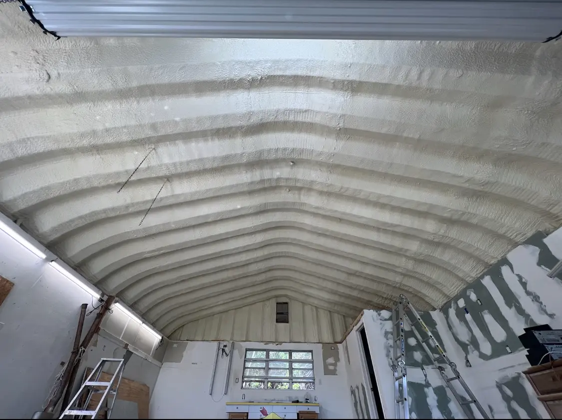 Spray polyurethane foam applied to the underside of a metal roof deck in Weston